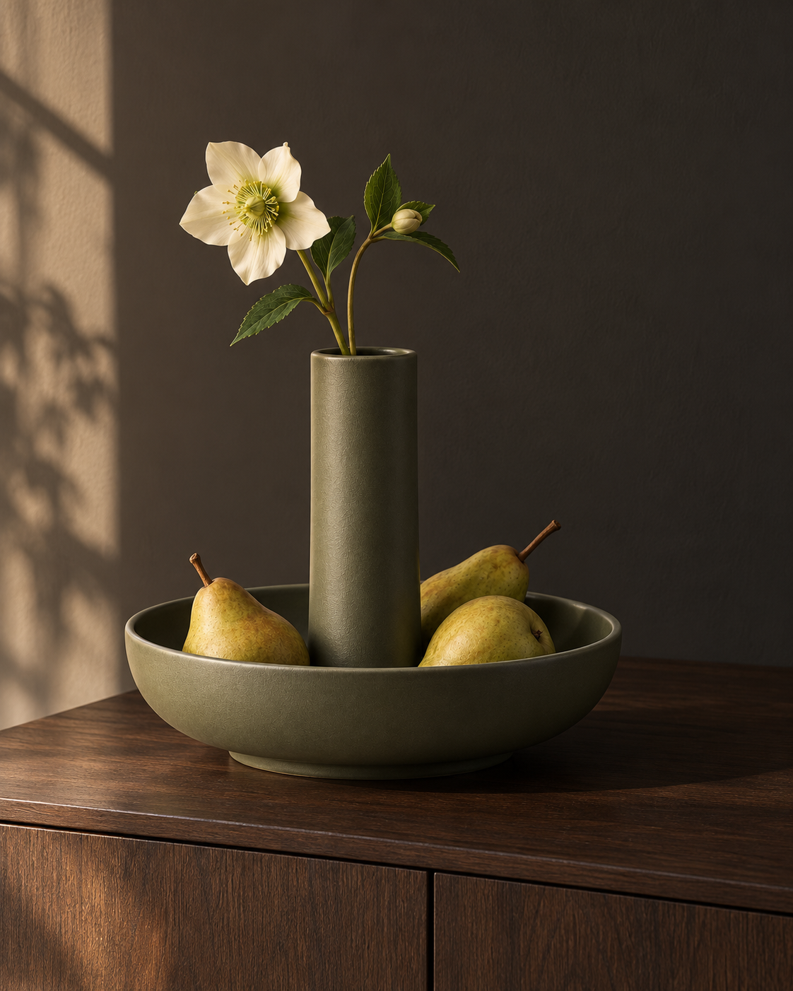 Column and bowl vessel on a wood sideboard